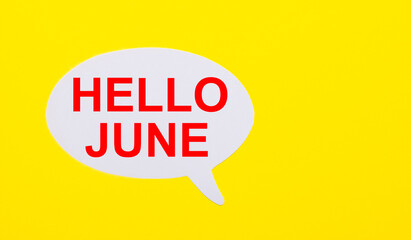 On a bright yellow background, white paper with the words HELLO JUNE
