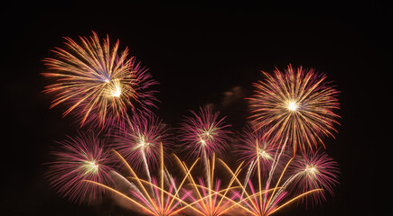 International fireworks festival display at night. Variety of colorful fireworks in holidays celebration isolated on black. Happy New Year Background. © tampatra
