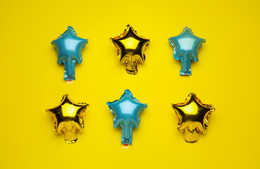 Balloons in shape of stars on color background