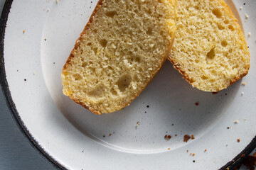 sliced simple  home made yogourt cake ,seen from above home cooking .