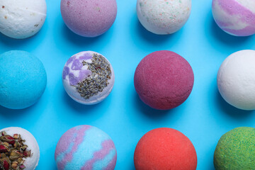 Colorful bath bombs on light blue background, flat lay