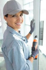 woman fixing windows with screwdriver