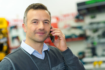 man talking on smart phone in the store