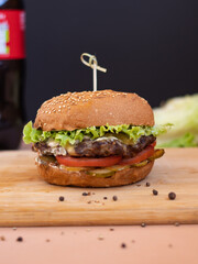 big burger in a cafe on a wooden table