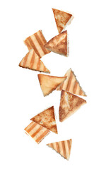 Delicious crispy pita chips falling on white background