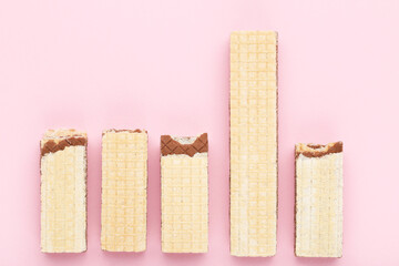 Sweet wafer sticks on pink background