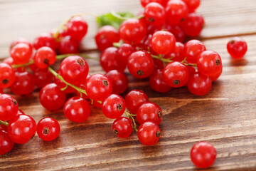 Sweet red currants on brown wooden background
