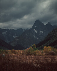 Russia, Caucasus, Dombay, Mountain peaks covered with dark gloomy clouds