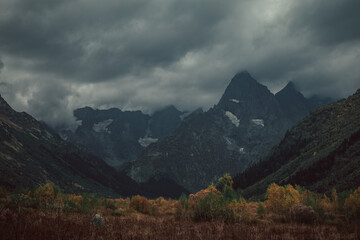 Russia, Caucasus, Dombay, Mountain peaks covered with dark gloomy clouds