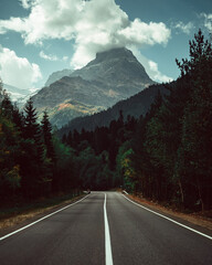 Russia, Caucasus, empty road to Dombay to Mount Belalakaya, peak in the clouds