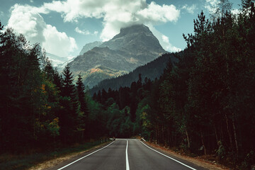 Russia, Caucasus, empty road to Dombay to Mount Belalakaya, peak in the clouds