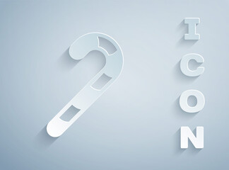 Paper cut Christmas candy cane with stripes icon isolated on grey background. Happy Halloween party. Paper art style. Vector