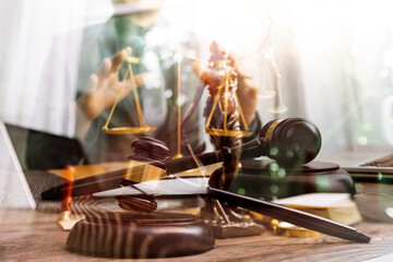 Business and lawyers discussing contract papers with brass scale on desk in office. Law, legal services, advice, justice and law concept picture with film grain effect