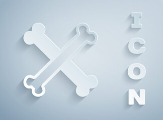 Paper cut Crossed bones icon isolated on grey background. Pets food symbol. Happy Halloween party. Paper art style. Vector