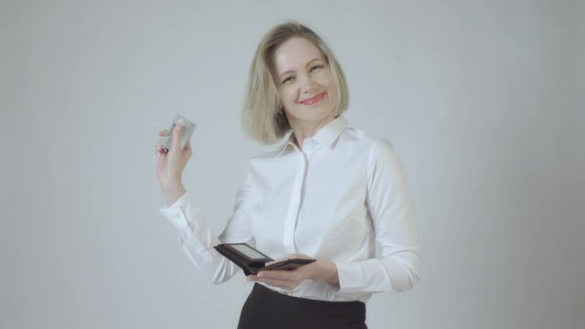 Young happy beautiful woman take bank card from her wallet and rejoices . 4K video.