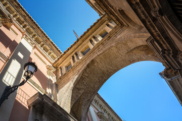 Fototapeta premium Perspective view of an ancient arch between Cathedral and Basilica Desamparados, Valencia, Spain
