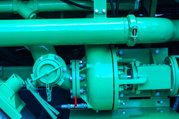 Green production equipment. Background consisting of green pipes. Production equipment close-up....