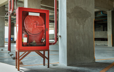 A red fire fighting equipment cabinet or fire extinguishing cabinet of fire protection set is...