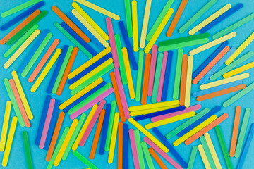 Randomly arranged multi-colored plastic sticks as a background, texture, pattern.