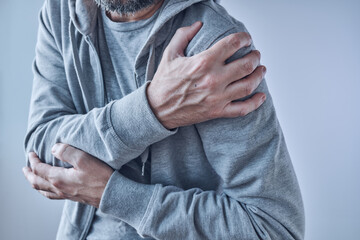 Shoulder joint pain, man with severe ache as symptom of osteoarthritis - obrazy, fototapety, plakaty