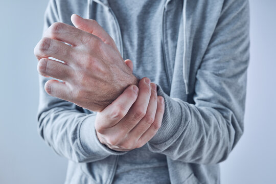 Rheumatoid arthritis, man suffering from severe pain in wrist