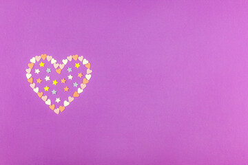 Heart lined with little hearts and stars on a purple background.