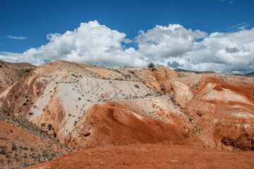 An unusual natural area in the Altai mountains with colored soil similar to the Martian landscape. Red mountains in Kyzyl-Chin valley, also called as Mars valley. Altai, Siberia, Russia