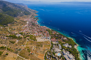 Fototapeta premium Panorama of town Bol on Brac island in Croatia - travel background. Aerial drone picture in august 2020