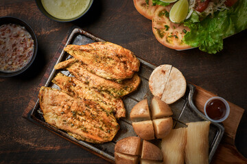 Grilled chicken fillet with dressings. Top view with copy space.