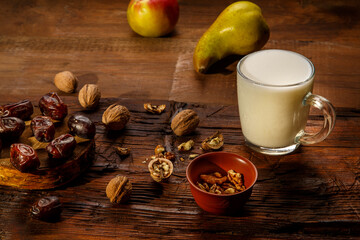 Food for iftar in holy ramadan on a wooden table dates, fruits and ayran.