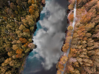 View of the river in the autumn forest from above. Beautiful panoramic view of the wildlife. Shooting from a drone. Wallpaper, screen saver, cover.
