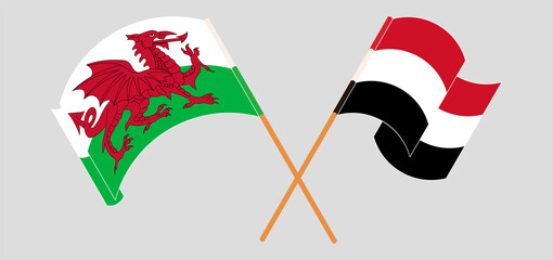 Crossed and waving flags of Wales and Yemen