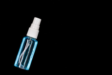 Instant alcohol hand sanitizer spray, antibacterial alcohol liquid in a clear bottle in black background. With space for free text