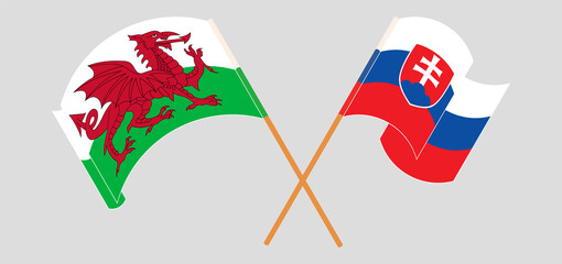 Crossed and waving flags of Wales and Slovakia