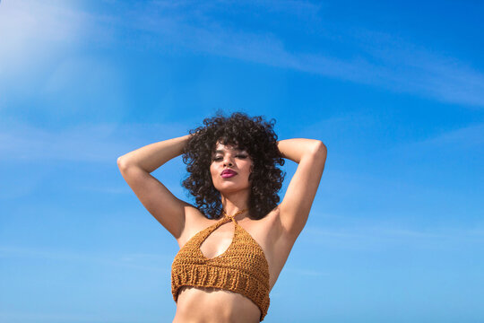 spectacular low angle photo of beautiful mexican woman with afro hair. latin girl