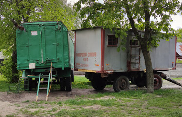 Fototapeta na wymiar Construction trailer for office, change houses. Close up photo of a construction trailer at a construction site. Inscription - no turns or stops, overtaking.