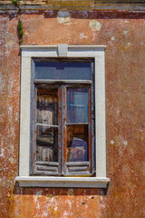 Fototapeta na wymiar Broken Window on a building in southern Portugal