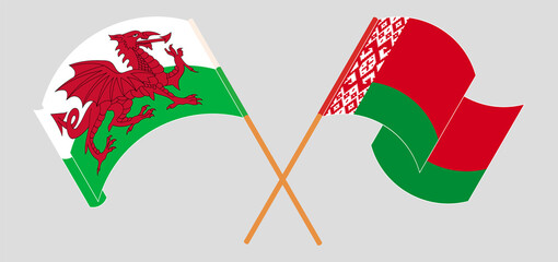 Crossed and waving flags of Wales and Belarus