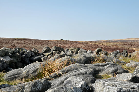  landscape with the exposed stones at the top of a cairn known as the millers grave on midgley moor in calderdale west yorkshire