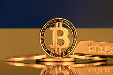 Physical version of Bitcoin, gold bar and Ukraine Flag.