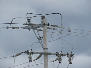 Wires and an electrical pole in a cloudy day
