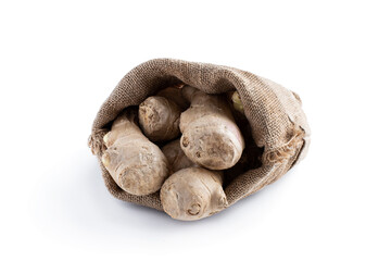 Fresh ginger roots in burlap bag isolated on white