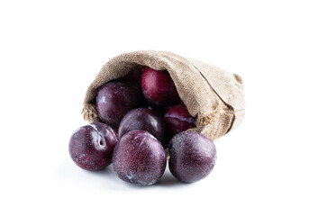 Fresh big plum in burlap bag isolated on white