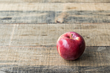 One fresh red apple on a wooden tabletop fruit diet
