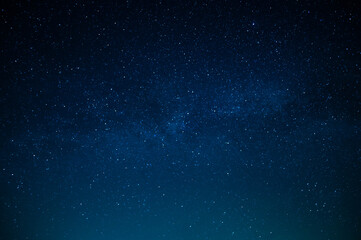 Beautiful night sky. Twinkling stars. Light clouds. Silence and eternity. Galaxy. Deep blue tones....