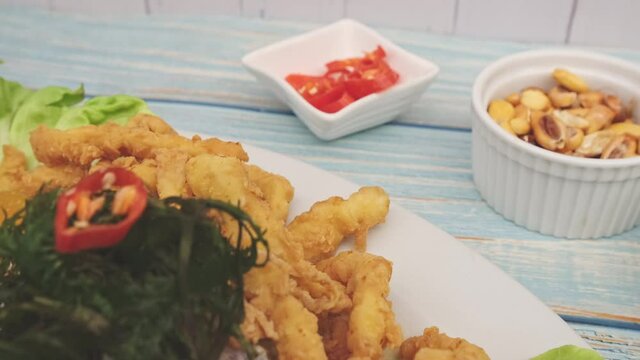 Traditional Peruvian ceviche accompanied by fish, corn pancake, sweet potato, canchita and plenty of spicy juice. Ceviche y chicharron de pescado
