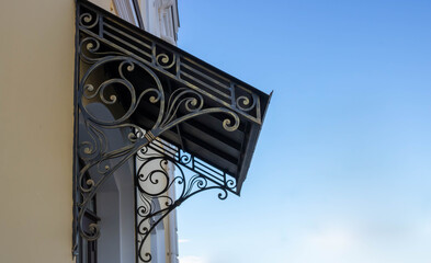 Old wrought iron awning over the door of an old house