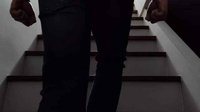 A man walking up the stairs in anger
