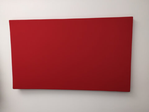 Piece Of Art On A White Wall In A Museum With Nothing But Plain Red Surface Paint