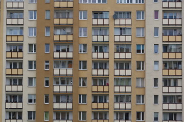 Urban stone jungle. Multiple windows on a large building in the city. Fragment of the facade of high-rise residential buildings. 